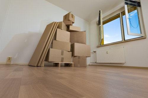 Movers carrying furniture through a residential apartment building in Mitcham