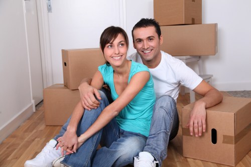 Family organising seasonal items for household storage in Mitcham