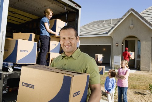 Professional movers carrying furniture during a Mitcham relocation